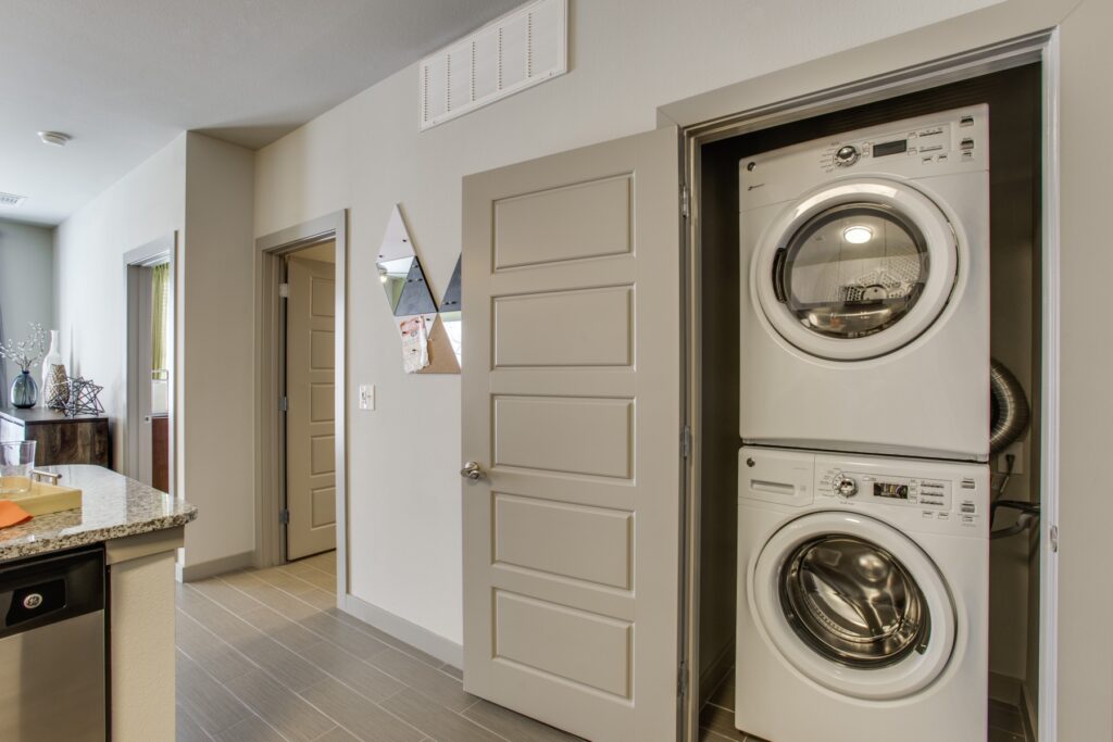 Laundry closet with stackable washer and dryer in the kitchen