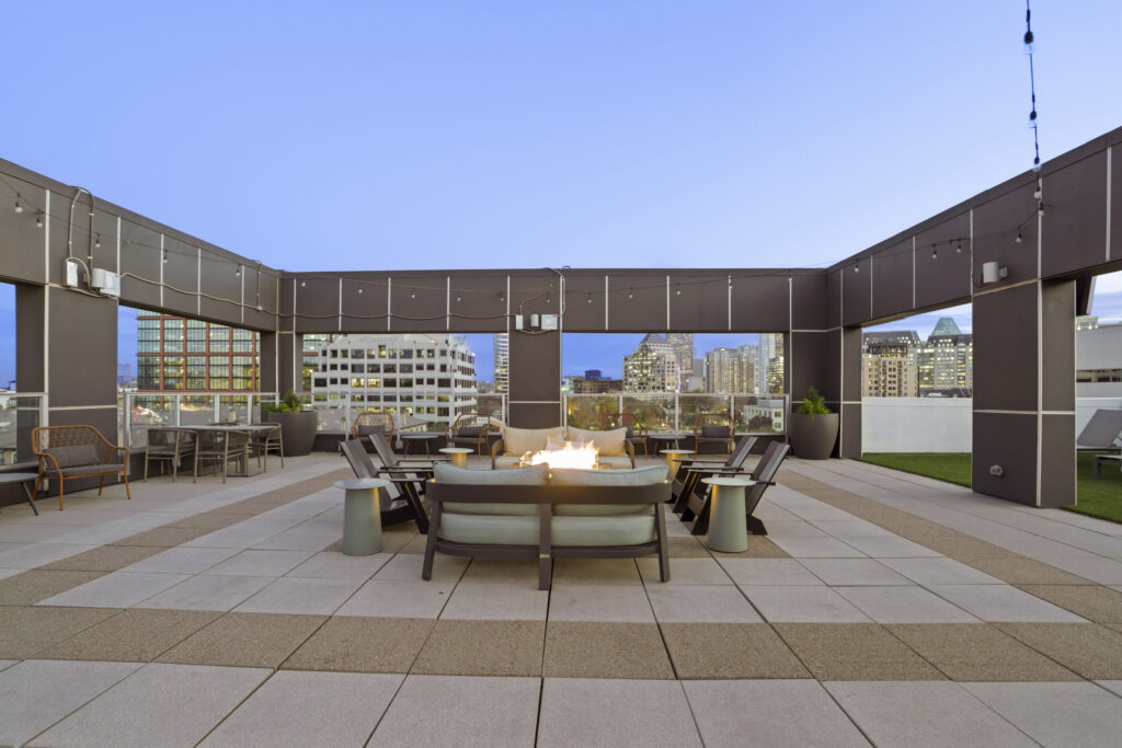 Rooftop lounge with fire pit and TV