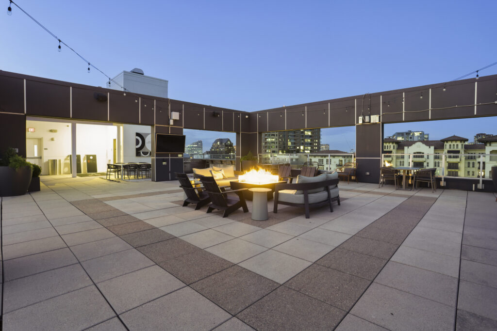 Rooftop lounge with fire pit and TV